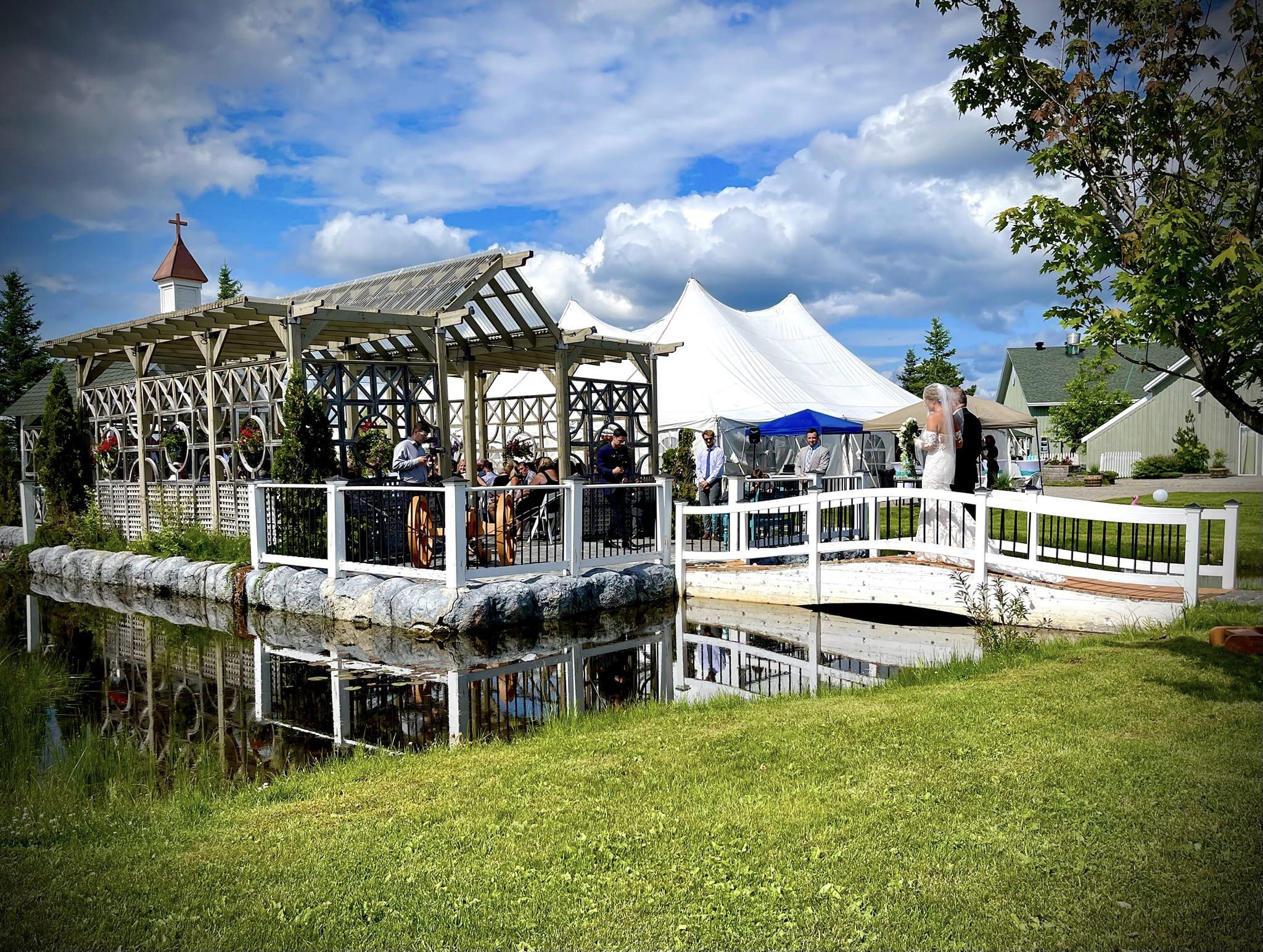 Cedar Meadows Spa & Resort A white tent on a grassy area next to a pond at Cedar Meadows Resort & Spa. - Timmins, Ontario