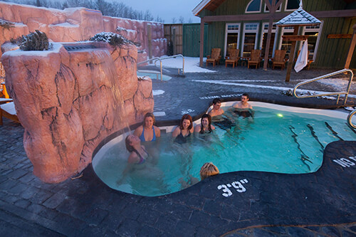 Cedar Meadows Spa & Resort A group of people enjoying a hot tub at Cedar Meadows Resort & Spa in Timmins, Ontario, amidst the snow. - Timmins, Ontario