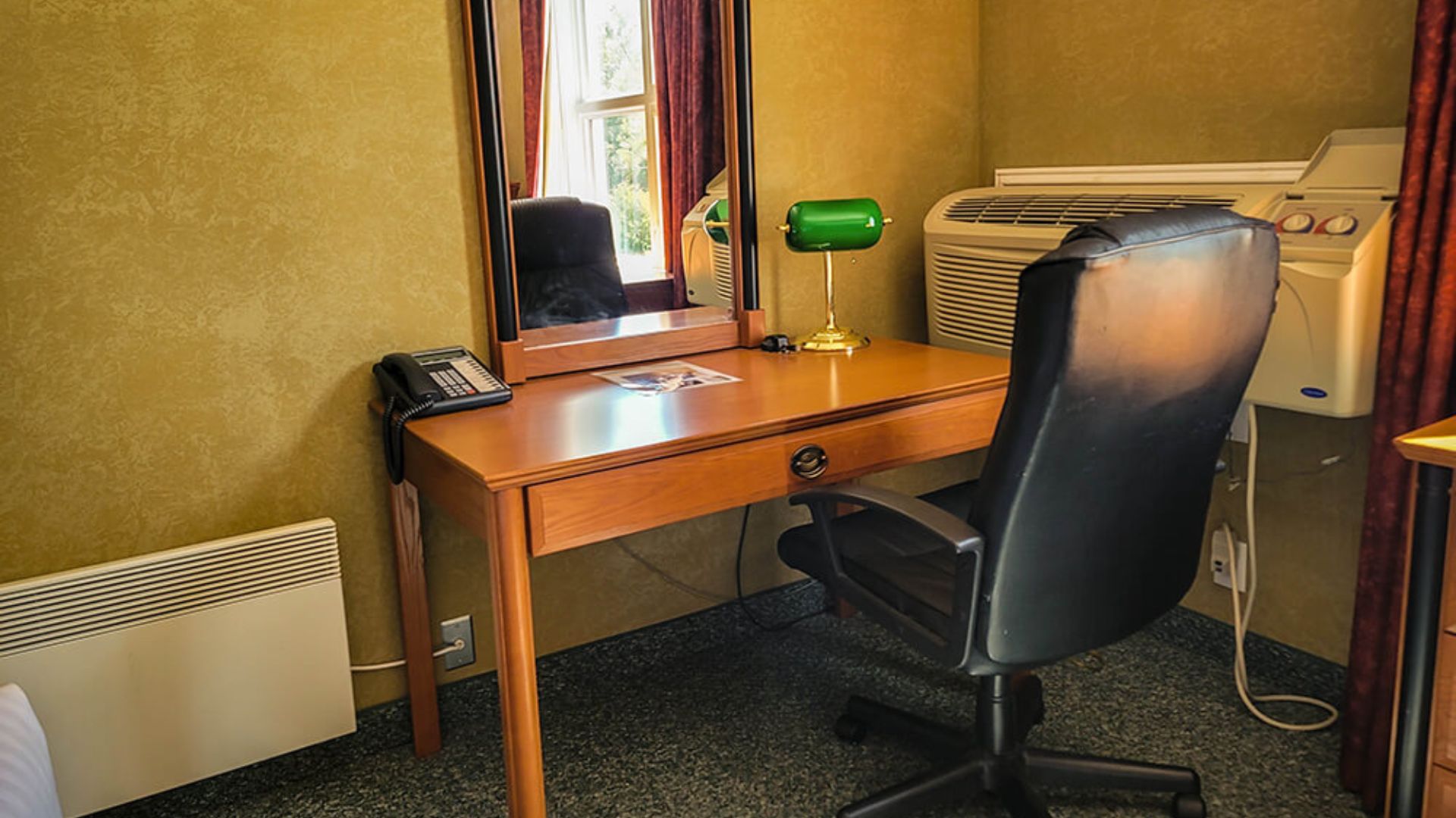 Cedar Meadows Spa & Resort A resort hotel room in Timmins, Ontario with a desk, chair, and air conditioner. - Timmins, Ontario