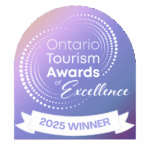 Cedar Meadows Spa & Resort Ontario Tourism Awards of Excellence 2025 Winner badge with a purple gradient background and white decorative dots. - Timmins, Ontario