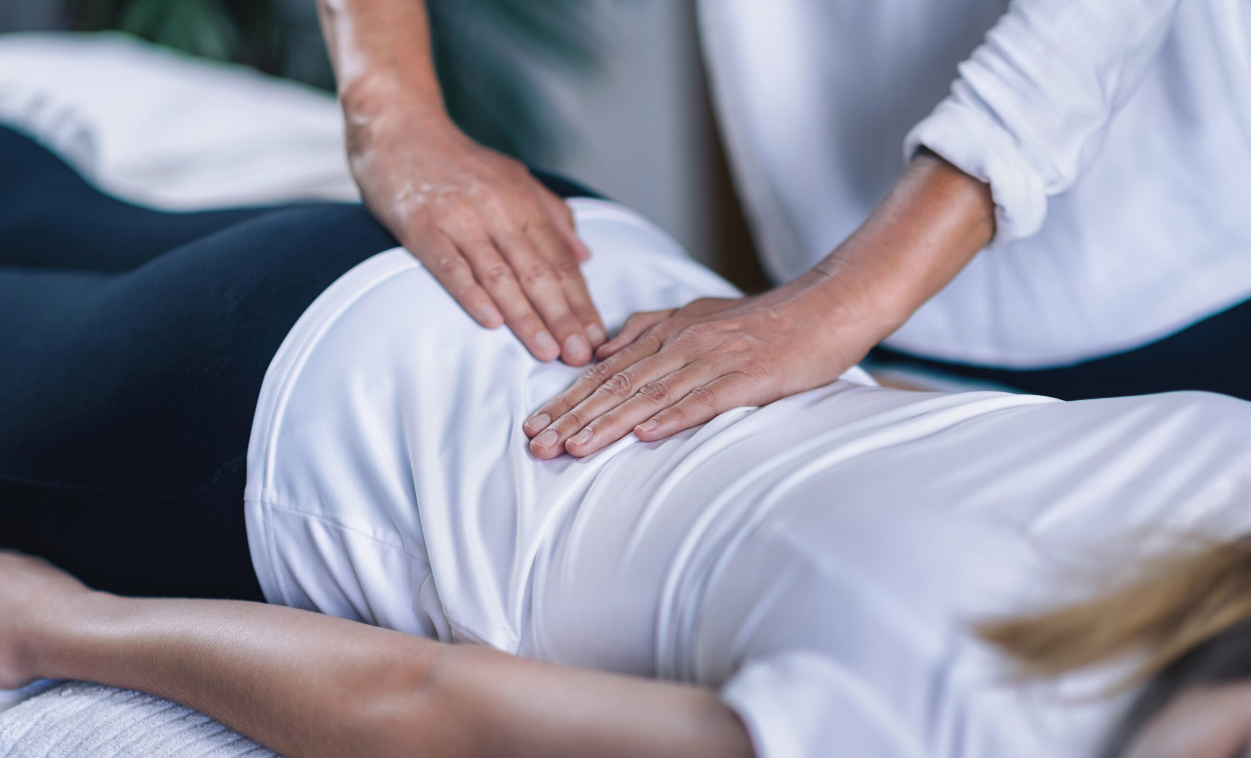Cedar Meadows Spa & Resort A person receives a massage on their lower back while lying face down on a table. - Timmins, Ontario